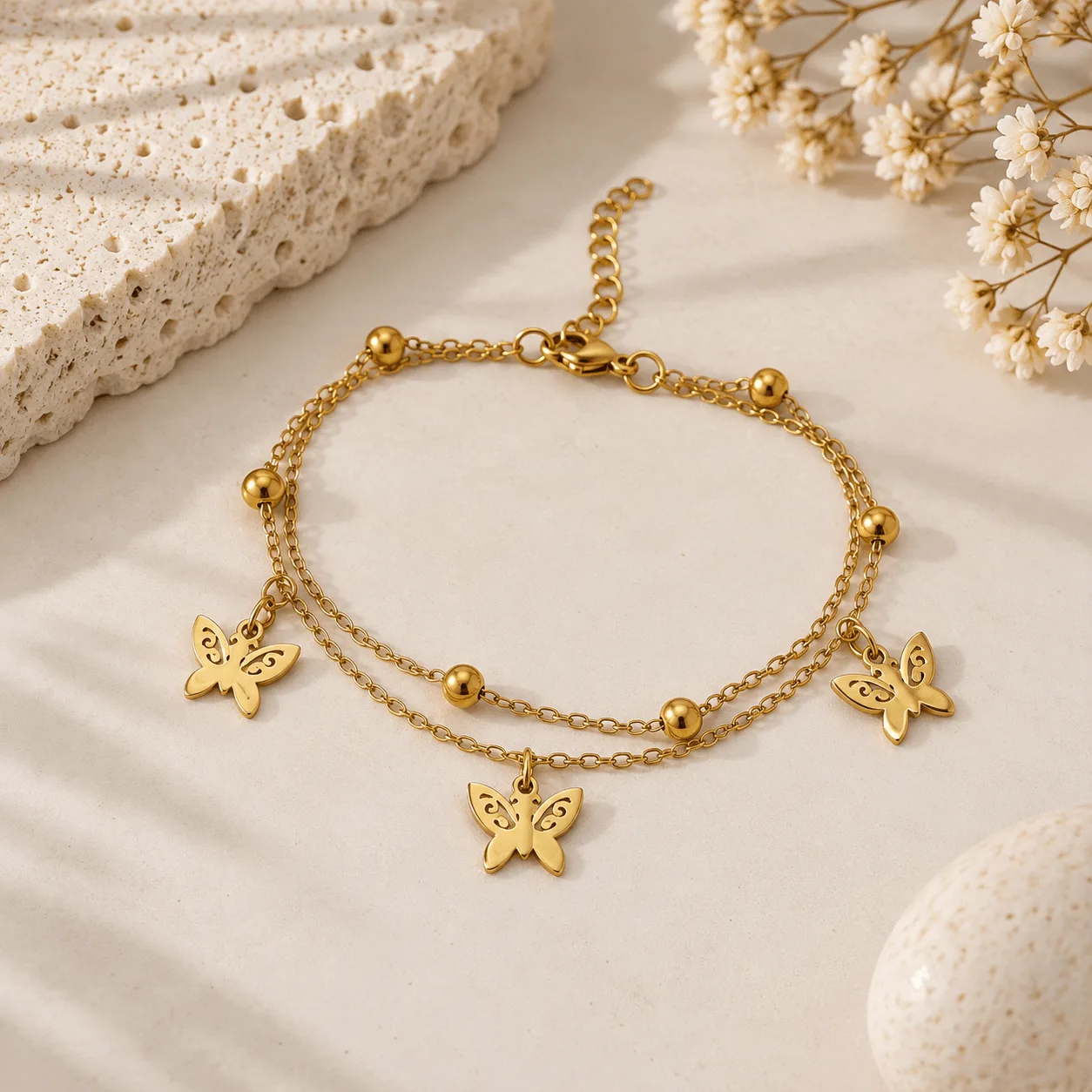 pulsera dorada doble pelotas y mariposas